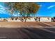 Front view of a manufactured home with mature tree and rock landscaping at 2881 W Cactus Wren St, Apache Junction, AZ 85120