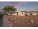 Side view of a manufactured home with rock landscaping and mature tree at 2881 W Cactus Wren St, Apache Junction, AZ 85120