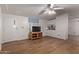 Living room with hardwood floors, a TV stand, and a ceiling fan at 2881 W Cactus Wren St, Apache Junction, AZ 85120