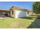 Home's back exterior and yard with a patio, grass, and an orange tree at 2911 W Lamar Rd, Phoenix, AZ 85017