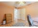 Bright bedroom with wood floors, double closet, and ceiling fan at 2911 W Lamar Rd, Phoenix, AZ 85017