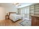 Bedroom with built-in shelves, wood floors, and ceiling fan at 2911 W Lamar Rd, Phoenix, AZ 85017