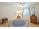 Bedroom with ceiling fan, wood floors, and window curtains at 2911 W Lamar Rd, Phoenix, AZ 85017