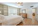 Bedroom with wood floors, built-in shelves, and ceiling fan at 2911 W Lamar Rd, Phoenix, AZ 85017