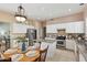 Bright kitchen with an island, white cabinets, and a dining area at 3165 E Indigo Bay Dr, Gilbert, AZ 85234