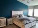 Bright bedroom with a king-size bed and teal accent wall at 3216 W Melody Dr, Laveen, AZ 85339