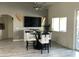 Modern dining area with glass table and white chairs at 3216 W Melody Dr, Laveen, AZ 85339