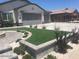 Landscaped front yard with artificial turf and stone accents at 3216 W Melody Dr, Laveen, AZ 85339