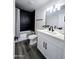 Stylish bathroom featuring sleek black tile in the shower, modern vanity, and updated fixtures at 3447 W Dailey St, Phoenix, AZ 85053