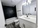 Modern bathroom with dark tile shower and white vanity at 3447 W Dailey St, Phoenix, AZ 85053