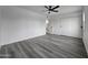 Spacious bedroom with ceiling fan and gray vinyl flooring at 3447 W Dailey St, Phoenix, AZ 85053