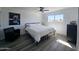 Serene bedroom with large window offering outside views, modern art, and stylish ceiling fan at 3447 W Dailey St, Phoenix, AZ 85053