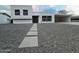 Modern home exterior with a clean, white design and gravel landscaping at 3447 W Dailey St, Phoenix, AZ 85053