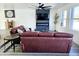 Beautiful living room with hardwood style floors, a modern fireplace, and lots of natural light at 3447 W Dailey St, Phoenix, AZ 85053