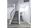 Modern staircase with gray wood-look flooring and black railing at 3447 W Dailey St, Phoenix, AZ 85053