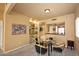 Dining area with glass table, four chairs, and built-in shelving at 4015 N 78Th St # 141, Scottsdale, AZ 85251