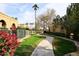 Landscaped walkway with lush greenery and vibrant flowers at 4015 N 78Th St # 141, Scottsdale, AZ 85251