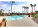 Inviting community pool with surrounding lounge chairs and palm trees at 4015 N 78Th St # 141, Scottsdale, AZ 85251