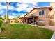 Large backyard with covered patio and grassy lawn area at 4043 W Saguaro Park Ln, Glendale, AZ 85310