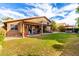 Large backyard with covered patio and grassy area at 4043 W Saguaro Park Ln, Glendale, AZ 85310