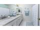 Bathroom with double sinks, stone countertops, and hexagon tile floor at 4043 W Saguaro Park Ln, Glendale, AZ 85310