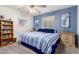 Bedroom with a bookcase and a bed with blue and white bedding at 4043 W Saguaro Park Ln, Glendale, AZ 85310