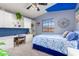 Spacious bedroom with built-in desk and blue color scheme at 4043 W Saguaro Park Ln, Glendale, AZ 85310