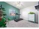 Bright bedroom featuring a treadmill and built-in dresser at 4043 W Saguaro Park Ln, Glendale, AZ 85310