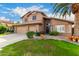 Two story house with a three car garage and well maintained lawn at 4043 W Saguaro Park Ln, Glendale, AZ 85310