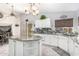 Kitchen features granite island, white cabinets, and stylish backsplash at 4043 W Saguaro Park Ln, Glendale, AZ 85310