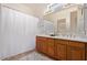 Bathroom with double sinks and wood cabinets at 42899 W Whimsical Dr, Maricopa, AZ 85138