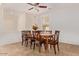 Dining room with wood table and chairs, tile floors, and a ceiling fan at 42899 W Whimsical Dr, Maricopa, AZ 85138