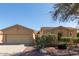 Tan two-story house with a two-car garage and landscaped front yard at 42899 W Whimsical Dr, Maricopa, AZ 85138