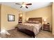 Large bedroom with ensuite bathroom access and ceiling fan at 4531 E Jude Ln, Gilbert, AZ 85298