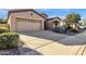 Tan colored stucco home with a two car garage and desert landscaping at 4531 E Jude Ln, Gilbert, AZ 85298