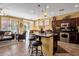 Spacious kitchen with island, stainless steel appliances, and dark wood cabinets at 4531 E Jude Ln, Gilbert, AZ 85298