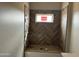 Bathroom undergoing construction with installed herringbone tile in the shower and a window for natural light at 48548 W Long Rifle Rd, Aguila, AZ 85320