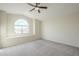 Bedroom with arched window and ceiling fan at 532 N Bell Dr, Chandler, AZ 85225