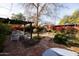 Landscaped backyard with pergola, seating area, and brick patio at 533 W Lewis Ave, Phoenix, AZ 85003