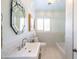 Bright bathroom with white sink and a large mirror at 533 W Lewis Ave, Phoenix, AZ 85003