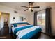 Bedroom with a teal comforter and access to hallway at 533 W Lewis Ave, Phoenix, AZ 85003