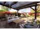 Backyard patio with pergola, seating area and dining table at 533 W Lewis Ave, Phoenix, AZ 85003