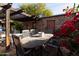 Outdoor dining area on a brick patio with wooden table and chairs at 533 W Lewis Ave, Phoenix, AZ 85003