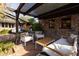 Relaxing patio area with pergola, comfortable seating, and brick flooring at 533 W Lewis Ave, Phoenix, AZ 85003