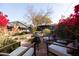 Outdoor patio with fire pit and seating area, surrounded by lush greenery at 533 W Lewis Ave, Phoenix, AZ 85003