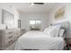 Bright bedroom with a white comforter and dresser at 5350 E Deer Valley Dr # 2403, Phoenix, AZ 85054