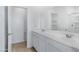 Double vanity bathroom with a large mirror and white cabinets at 5429 S 23Rd Dr, Phoenix, AZ 85041