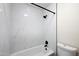 Clean bathroom with a bathtub and marble-look tile at 5711 N 24Th Pl, Phoenix, AZ 85016