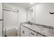 Updated bathroom with granite countertop and marble-look tile at 5711 N 24Th Pl, Phoenix, AZ 85016