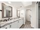 Updated bathroom with double vanity, granite countertop, and mosaic mirror frames at 5711 N 24Th Pl, Phoenix, AZ 85016